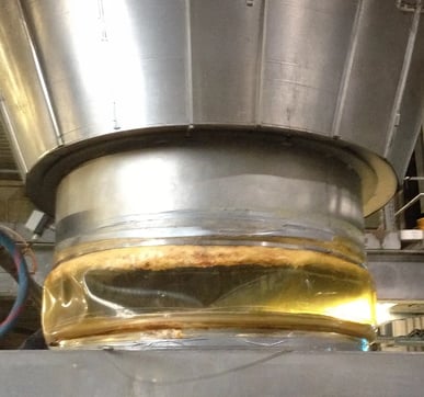 Product build up on clamped connector at base of silo