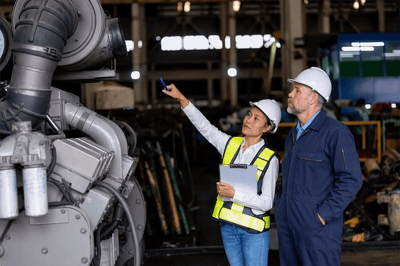 engineers-inspecting-machinery-at-industrial-manufacturer