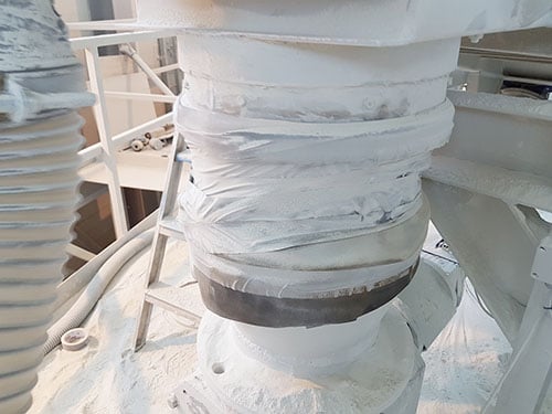 A leaking hose-clamped flexible connector.